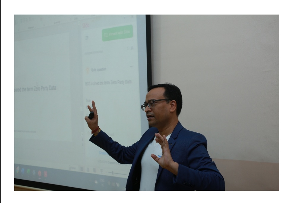 Anil Pandit presenting beside a classroom projection screen